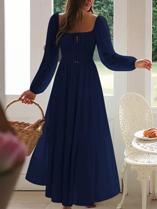 Detailed view of dark blue long sleeve tiered maxi dress with square neck and tie front