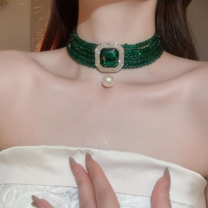 Detail of multi-layer emerald green bead choker with square gemstone and pearl drop