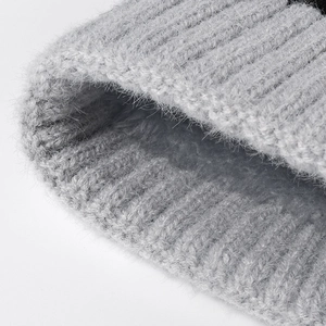 Thick knit pompom beanie for women featuring premium fluffy grey wool texture and warm lining