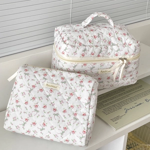 Quilted floral cosmetic bag set with pink rose and green bow patterns on white cotton