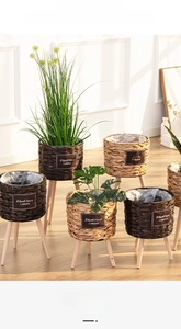 Close-up of hand-woven straw flower baskets with decorative wooden tripod stands