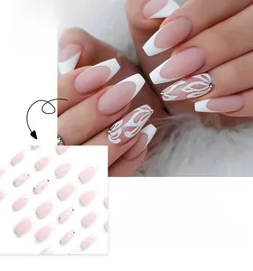 Macro detail of French tip press-on nails with silver glitter floral accents and nude base
