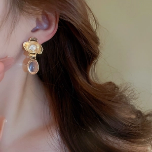 Detail showing vintage french style metallic flower earring with pearl and pink stone