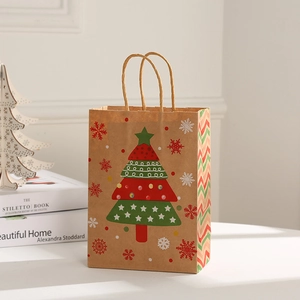 Detail of Christmas kraft paper gift bag featuring festive tree patterns and rope handles