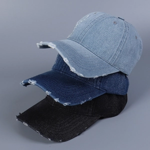 Detailed view of three distressed denim baseball caps in light blue, dark blue and black