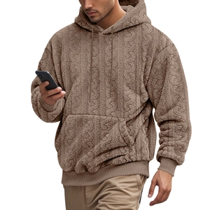 Macro detail of men's teddy fleece hoodie showing jacquard knit texture and kangaroo pocket