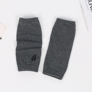 Detailed knit texture of grey fingerless arm warmers with thumb hole design