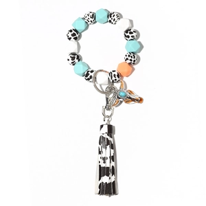 Glow-in-the-dark cow head metal keychain with colorful silicone bead wristlet and tassel