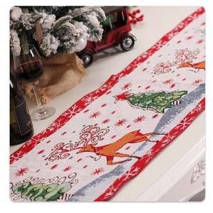 Close-up of festive Christmas table runner with reindeer embroidery and snowflake patterns