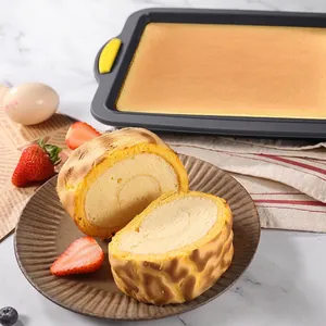 Non-stick rectangular baking pan with yellow silicone handles for brownies and cakes