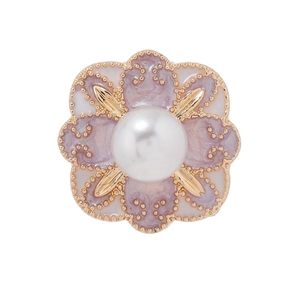 Vintage flower brooch with lavender enamel, central pearl and gold plating on white background