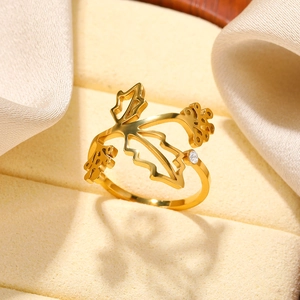 Detailed shot of gold leaf-shaped stainless steel ring with zircon in a velvet jewelry box