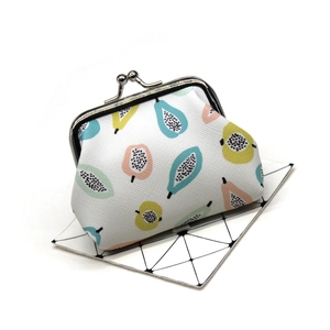 Close-up of fruit print coin purse with vintage silver metal clasp and textured surface