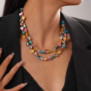 Detail of colorful irregular shell beads and gold spacers on a layered necklace
