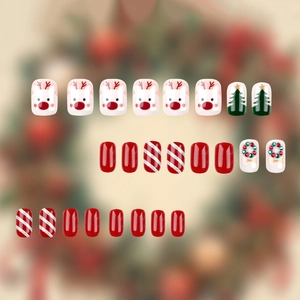 Christmas press-on nails set with red reindeer, green trees and glitter stripes