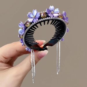 Close-up of purple flower hair clip with sparkling rhinestones and dangling tassels