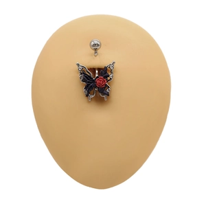 Detail of butterfly and red rose belly ring with white crystals on silicone skin model
