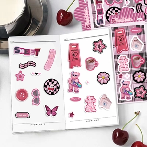 Detailed view of pink retro DIY stickers for scrapbooking with cute bear and floral motifs