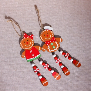 Handcrafted wooden gingerbread man and woman ornaments for Christmas tree decoration