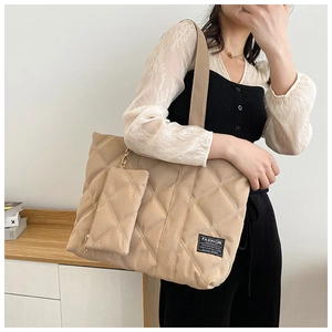 Detail of khaki quilted nylon shoulder bag with matching rectangular coin purse accessory
