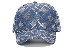 Detailed close-up of blue denim baseball cap with silver sequins and diamond pattern