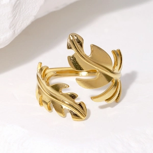 Detail of gold tropical monstera leaf ring showing overlapping leaf texture and finish