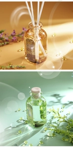 Detail of reed diffuser glass bottles with yellow and green oils in elegant settings