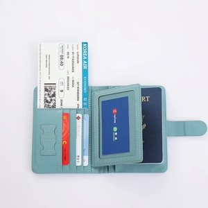Detail view of cyan leather passport holder with multi-layer card slots and SIM compartments