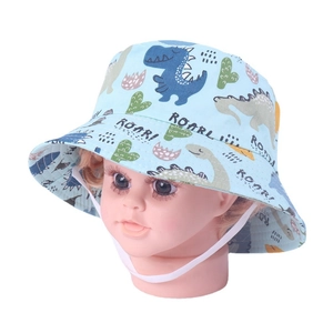 Detail of baby sun hat with blue dinosaur patterns and white adjustable chin strap