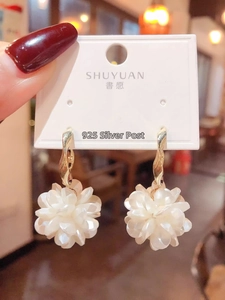 Detail of floral earrings featuring multi-layer pearlescent petals and 925 silver hooks