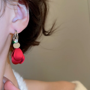 Macro shot of dark red petal tassel earrings with zircon stud worn by a model