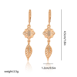 Detail view of champagne gold earrings with zircon settings and dimensional markings
