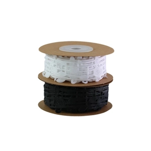 Detail of black and white musical note lace ribbons on vintage paper spools