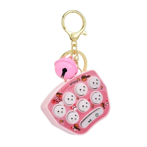 Pink mini Whac-A-Mole keychain with gold ring and bell featuring cartoon gaming buttons