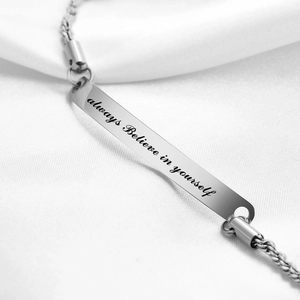 Close-up of Always Believe in Yourself engraved stainless steel curved plate bracelet