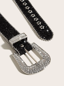 Macro view of Y2K rhinestone belt featuring silver star eyelets and a vintage buckle