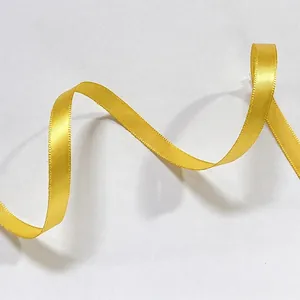 Detail of bright yellow satin ribbon with smooth finish for gift wrapping and DIY crafts
