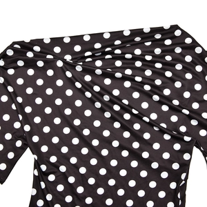 Close-up of soft black fabric with white polka dots showing detailed texture and drape
