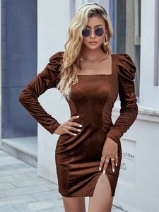 Detailed texture of dark brown velvet dress with elegant square neck and puff sleeves