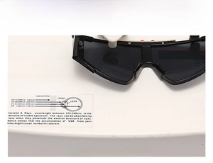 UV400 testing of oversized retro sunglasses showing 400nm protection on a lens tester