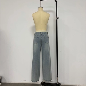 Rear view of light blue wide-leg denim jeans on mannequin with back pocket details