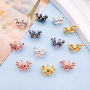 Macro shot of colorful rhinestone crown charms for DIY jewelry making in multiple finishes