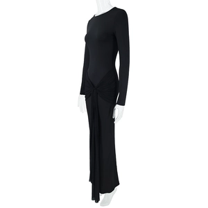 Detail view of the side-knotted ruche on a slim-fit black long-sleeve maxi dress