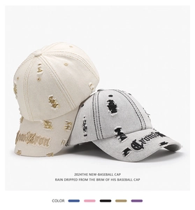 Detail of distressed baseball cap with embroidery and frayed torn holes in street style