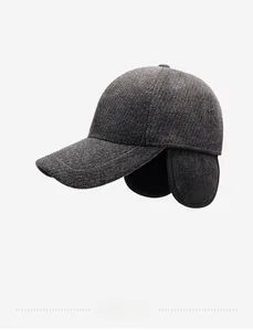 Detail of dark grey winter baseball cap featuring textured wool fabric and warm ear flaps