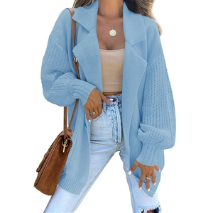 Close-up of light blue knitted cardigan featuring wide lapels and ribbed cuff details