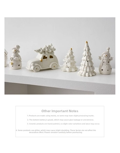 Detailed view of white ceramic Christmas figurines with gold dots and built-in LED lights