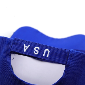 Adjustable back strap of navy blue US flag cap with white USA embroidery detail