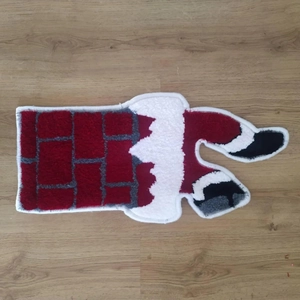 Detail of plush Christmas Santa chimney rug with non-slip texture on wooden floor