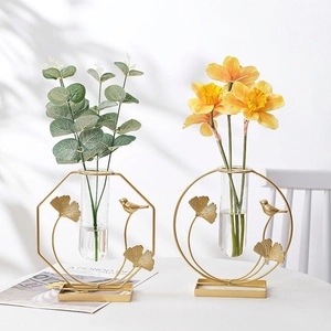 Nordic gold metal frame vases with bird and ginkgo leaf decor on white background